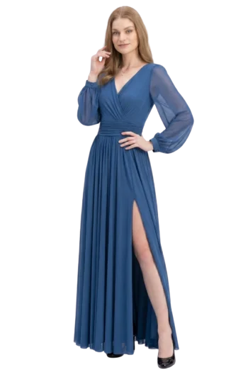 Woman in a blue evening gown with sheer long sleeves and a high slit, posing with one hand on her hip.