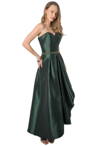 Woman in an emerald green strapless satin evening gown with a beaded belt, posing with one hand on her hip.