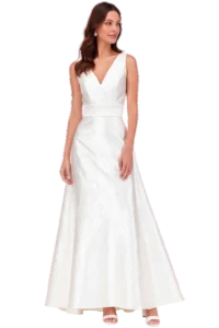 Bride in a white sleeveless wedding gown with a V-neckline and drop earrings, standing and looking to her left."