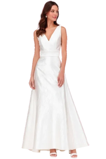 Bride in a white sleeveless wedding gown with a V-neckline and drop earrings, standing and looking to her left."