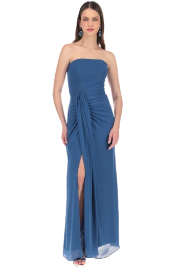 Full-length image of a woman in a blue strapless evening gown with a gathered drape and high slit, wearing turquoise earrings.
