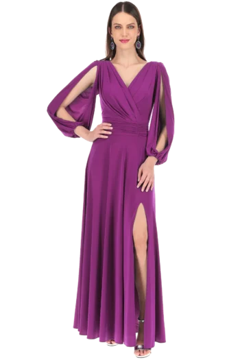 Woman in a floor-length purple gown with cape sleeves and a thigh-high front slit, wearing statement earrings.