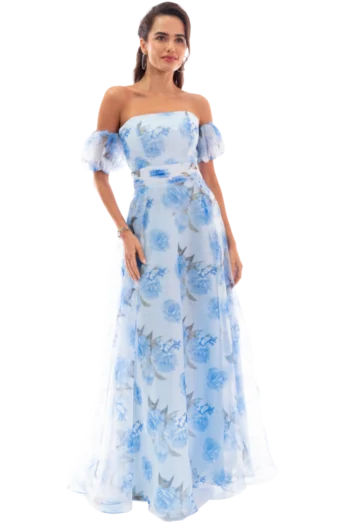 Woman in a light blue floral off-shoulder gown, standing and facing slightly left, with her hair pulled back and subtle jewelry.