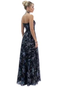 Profile of a woman in a strapless, dark floral gown with an updo bun, visible neck tattoo, and large hoop earrings.