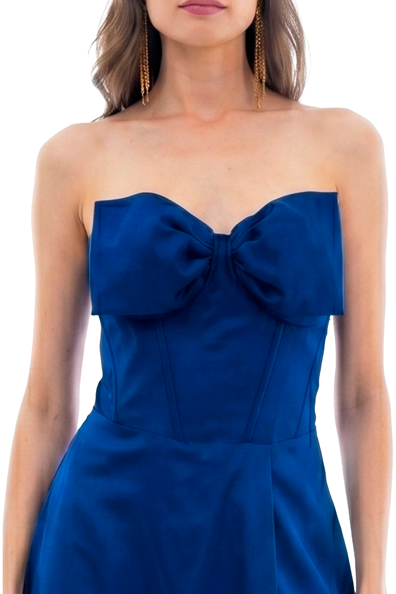 Woman wearing a blue strapless dress with a bow at the chest and long gold dangling earrings.