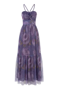 Purple floral maxi dress with thin halter straps and a gathered waist, featuring a sheer, layered skirt and a flower accent at the bodice.