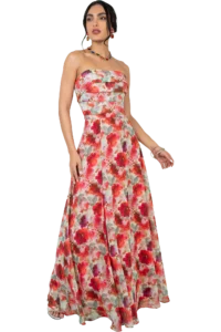 Model wearing a strapless, floor-length floral gown in red, pink, and green tones, accessorized with colorful jewelry and a bracelet.