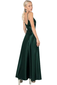 Woman wearing an emerald green satin evening gown seen from behind, open back and thin straps, with turquoise earrings.