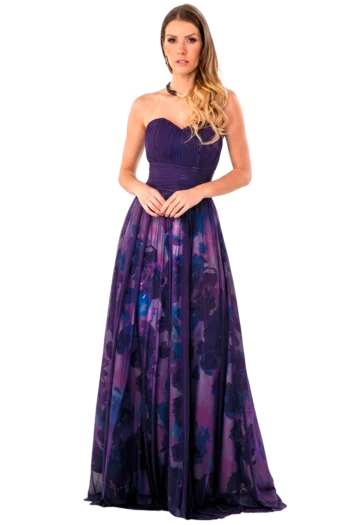 Woman in a long purple strapless gown with a gradient floral skirt, standing with hands clasped.