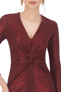 Upper torso of a person wearing a shimmering burgundy wrap dress with a front twist knot and V-neckline.