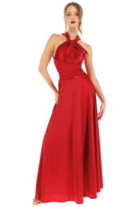 Full-length red halter-neck evening gown on a model, standing with hands on hips against a black studio background.