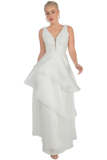 Bride wearing a sleeveless white wedding gown with a lace bodice and tiered, cascading ruffled skirt.