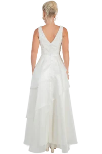 Bride wearing a white lace-back wedding dress, back view with a V-shaped neckline and tiered, flowing skirt