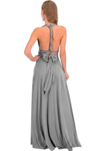 Back view of a woman wearing a gray backless evening gown with braided halter straps and a large bow at the waist/lower back.