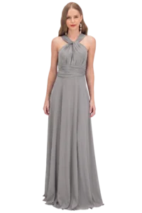 Woman in a long gray halter-style evening gown standing against a black background.