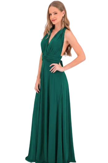 Full-length photo of a woman in a green evening gown posing with one hand on her hip against a black background.
