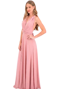 Full-length view of a woman in a pink halter-style evening gown, posing with one hand on her hip against a black background.
