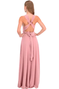 Back view of a woman in a pink formal gown with crisscross back straps and a bow at the waist