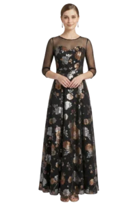 Woman modeling a black floor-length floral gown with sheer mesh sleeves, hands gently clasped at waist.