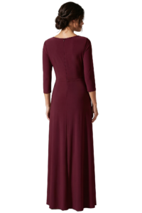 Back view of a woman in a burgundy, floor-length dress with three-quarter sleeves and an updo hairstyle.