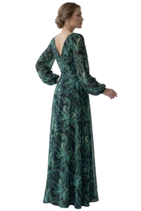 Woman in a long green tropical leaf print dress, viewed from the back/side with an elegant updo hairstyle, standing.