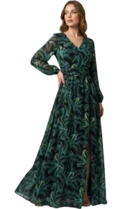 Woman in a long, dark green dress with leafy print, standing with one hand on hip and leg visible through a slit.