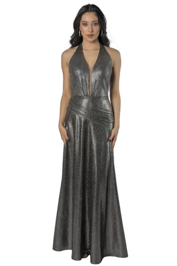 Woman in a shimmering silver halter gown, standing with arms at her sides against a black background.
