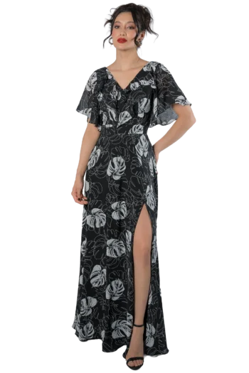 Vestido largo negro con estampado tropical de hojas blancas, escote en V y mangas tipo olán, modelo Massima colección otoño-invierno, vista frontal