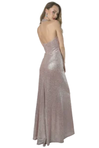 Woman in a sparkling pink backless gown, turned slightly to look over her shoulder, wearing large chandelier earrings.