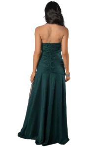 Back view of a woman in a sparkly teal strapless evening gown with ruching down the center and a long flowing train, wearing a silver bracelet on her right wrist
