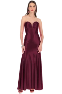 Full-length burgundy satin strapless gown on a model with red lipstick and statement earrings.