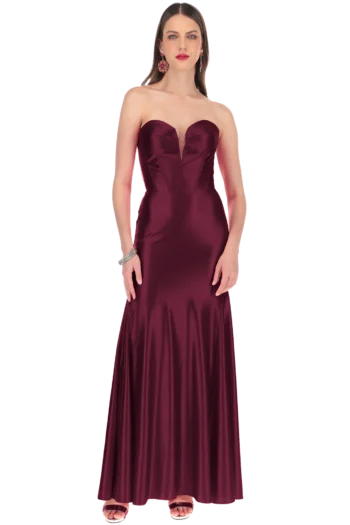 Full-length burgundy satin strapless gown on a model with red lipstick and statement earrings.