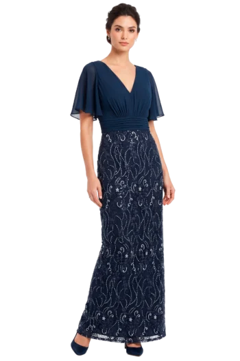 Woman wearing a navy blue evening gown with a V-neck bodice, flutter sleeves, and a lace-patterned floor-length skirt, standing against a neutral background.