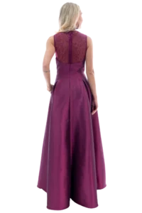 Woman in a floor-length magenta dress shown from the back, lace bodice and full skirt visible