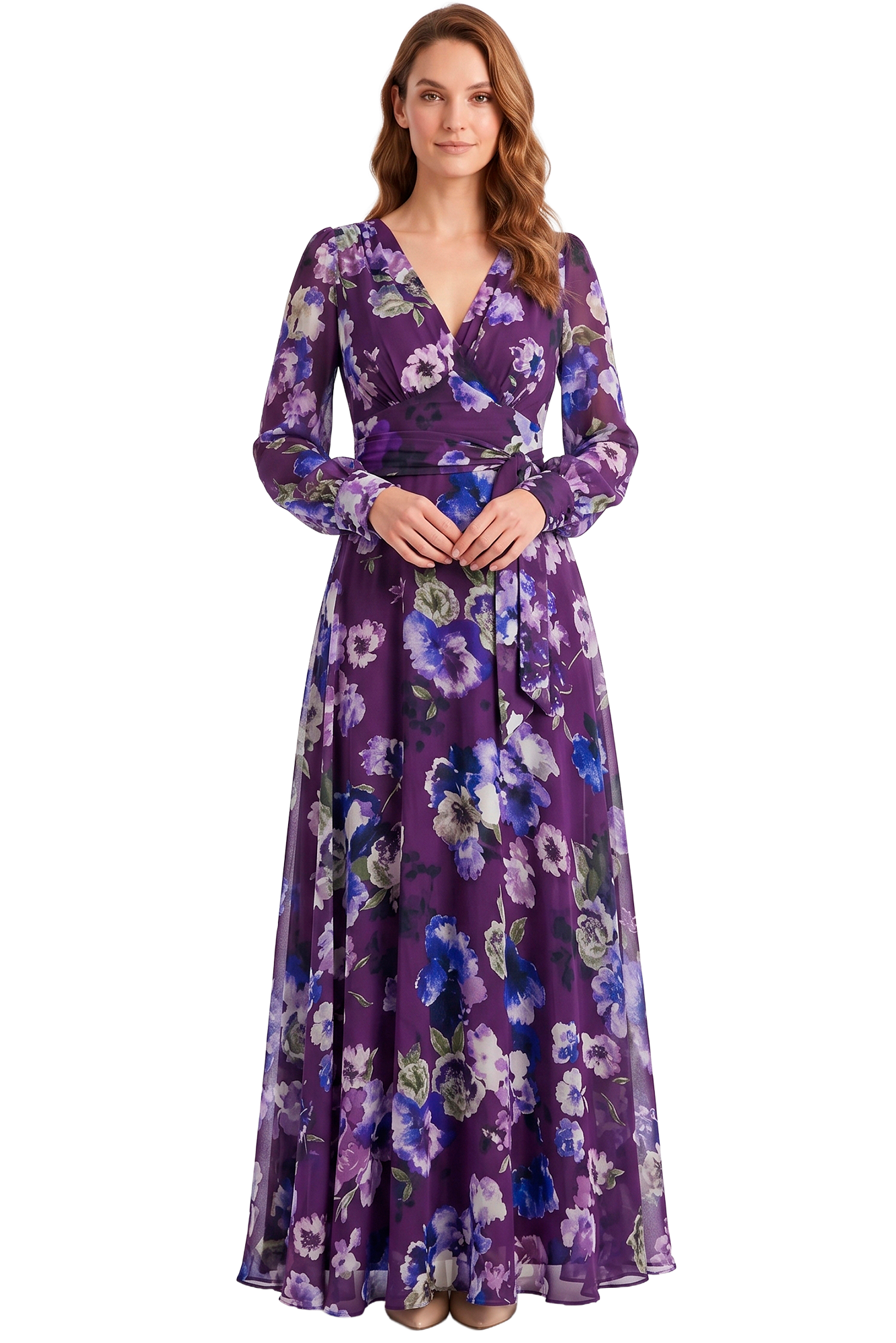 Full-length woman in a purple floral wrap dress, hands clasped, facing the camera.
