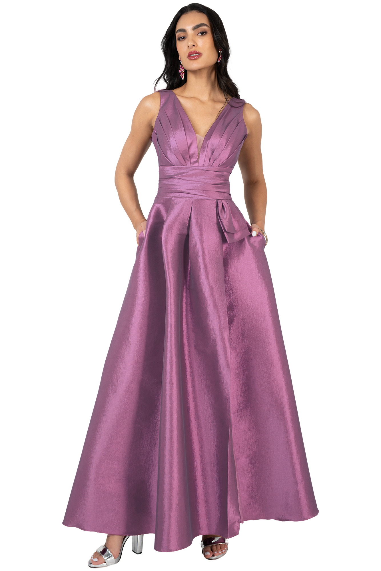 Full-length view of a woman in a mauve satin evening gown with a plunging V-neck and pockets, posing with hands in pockets.