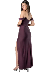 Back view of a woman wearing a burgundy off-shoulder gown with a back zipper and a high slit, standing in silver heels.