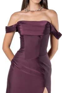 Woman in a burgundy off-the-shoulder satin gown with a crystal flower necklace.
