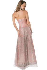 Back view of a woman in a pink strapless gown with silver lace, holding a clutch and wearing chandelier earrings.