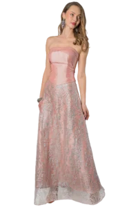 Woman in a strapless pink satin evening gown with a silver lace overlay, posing sideways with statement earrings.