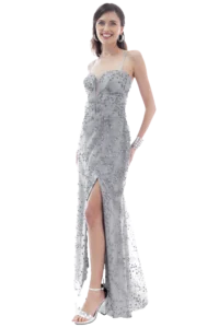 Woman in a silver sequined evening gown with a thigh-high slit, smiling and posing sideways against a transparent background.