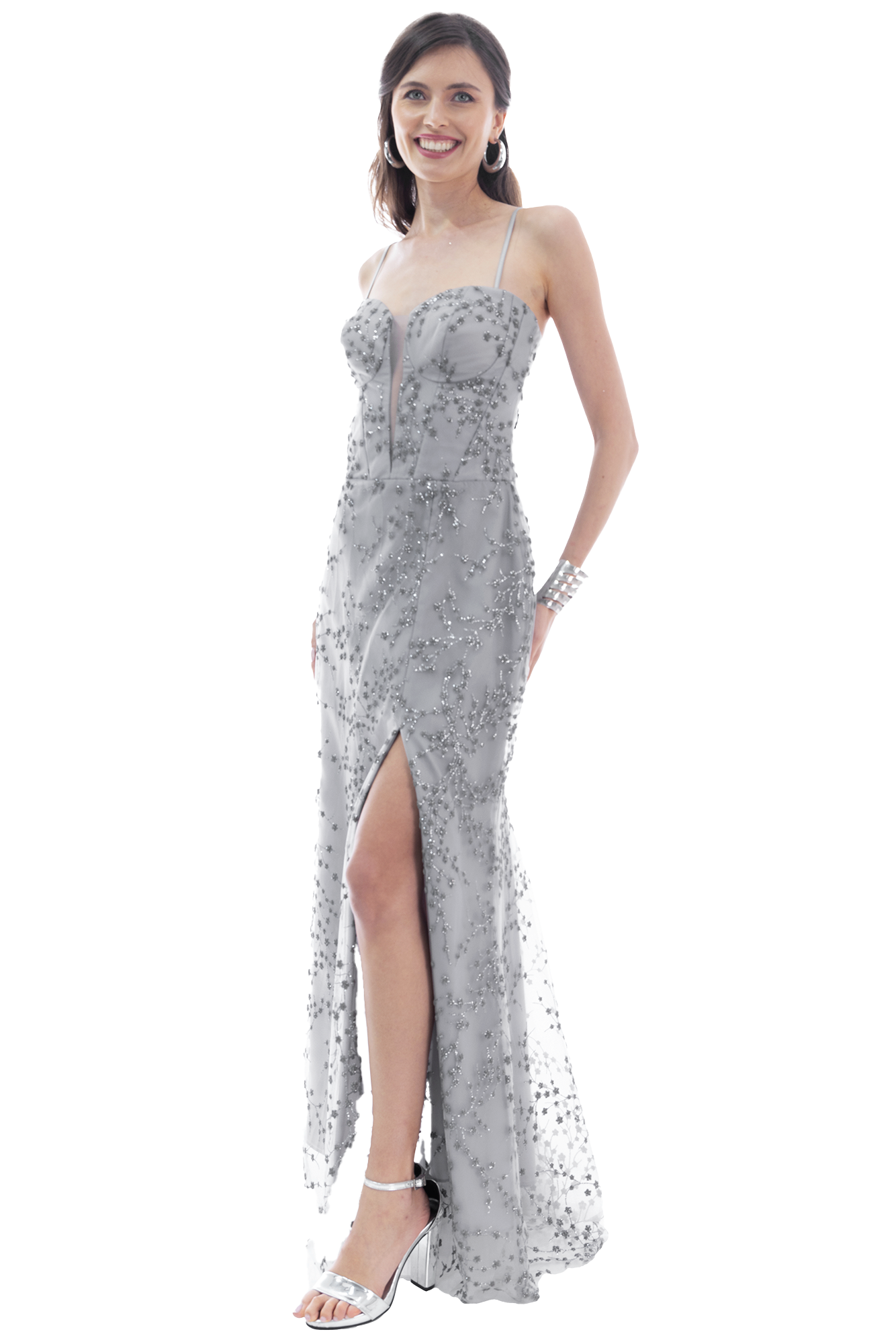 Woman in a silver sequined evening gown with a thigh-high slit, smiling and posing sideways against a transparent background.