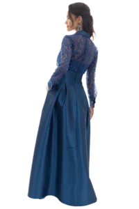 Profile of a woman wearing a blue lace evening dress with matching earrings, looking to the left.