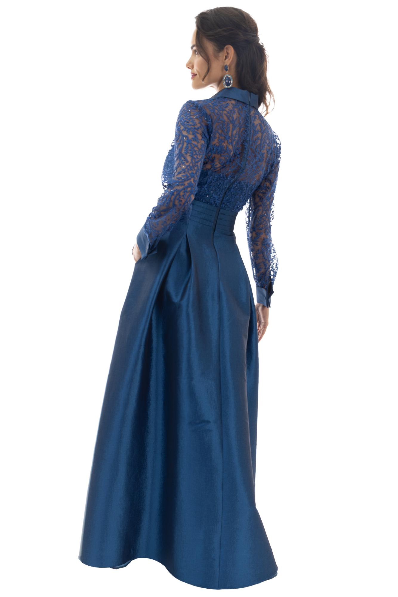 Profile of a woman wearing a blue lace evening dress with matching earrings, looking to the left.