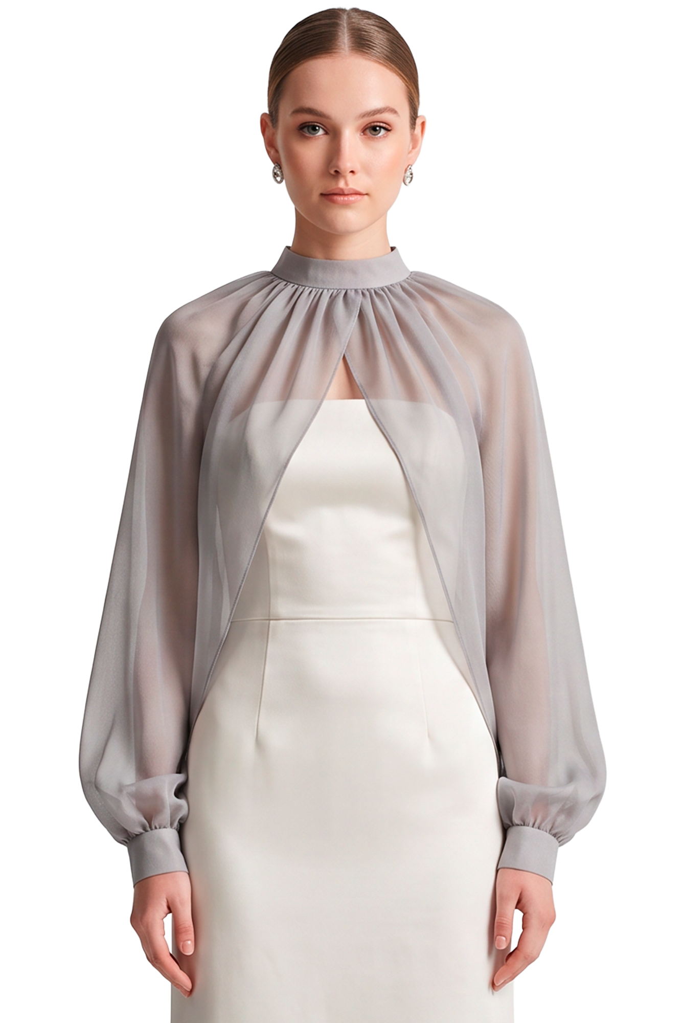 Portrait of a woman in a pale gray sheer cape over a white sheath dress, looking straight ahead.