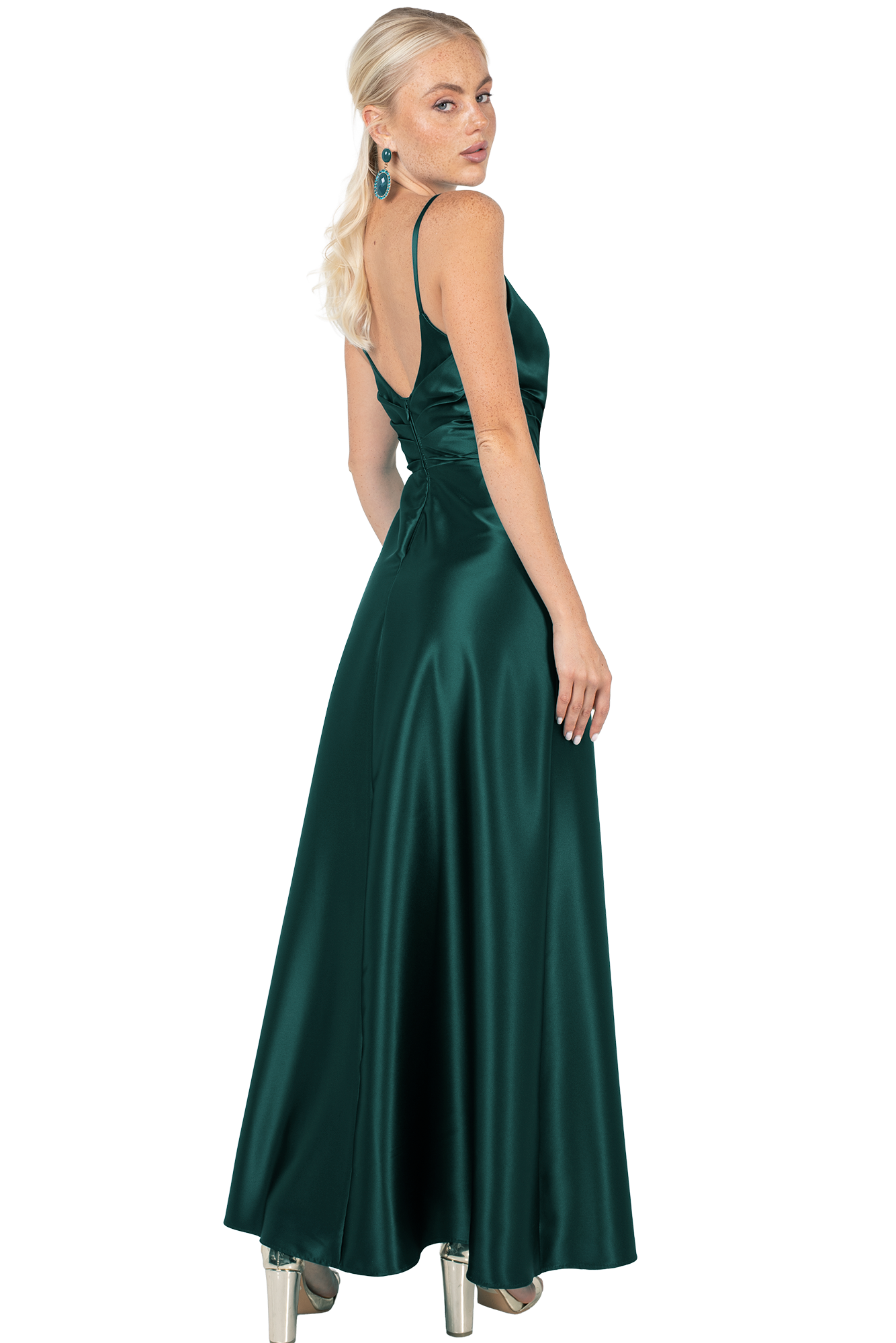 Woman in a dark emerald satin gown, back slightly turned, looking over shoulder; long blonde hair, statement earrings.