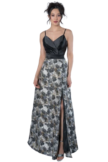 Woman in a black satin sleeveless top and a patterned, high-slit skirt posing against a black background.
