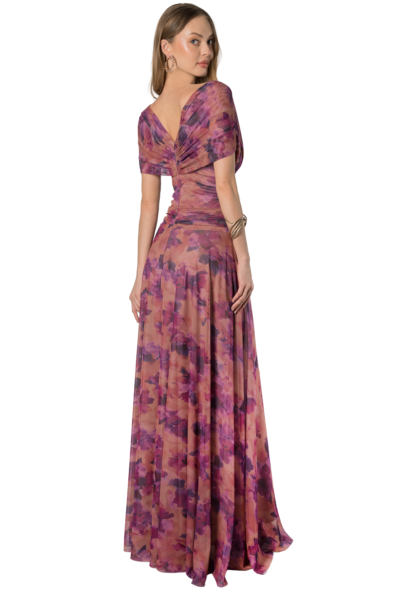 Woman in a pink‑purple floral off‑the‑shoulder gown, standing with her back and shoulders turned slightly toward the camera.