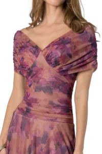 Close-up of a pink and purple floral off-the-shoulder dress with gathered draping at the bodice? seam detail is visible and fabric wraps across the chest to form a V shape.