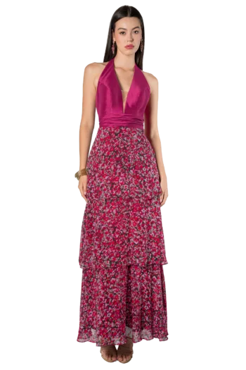 Invitada a boda luciendo un vestido largo coctel escote halter en tono fucsia estampado, con top de tafeta, escote en V con transparencia y falda de chiffon con olanes por niveles.